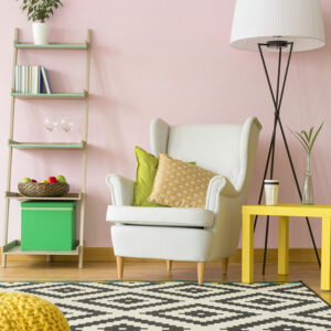 63723446 - cozy room in pale pink with comfortable armchair and simple floor lamp
